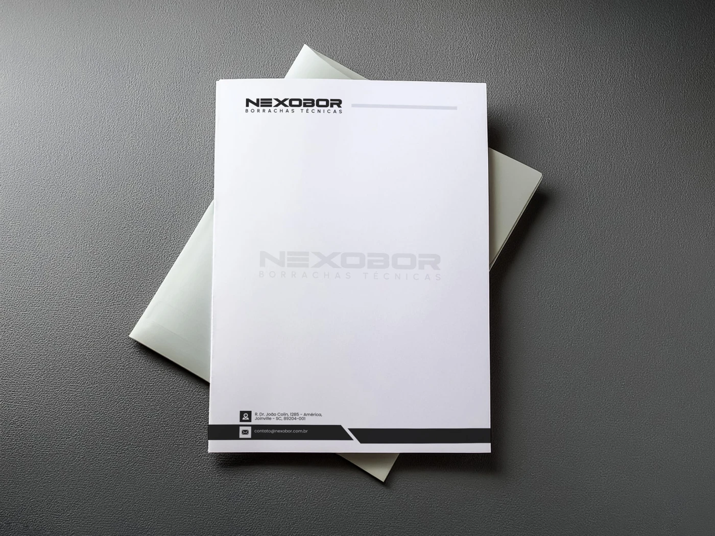 Arte de papel timbrado para indústria Nexobor Borrachas Técnicas com marca d'água e rodapé informativo.